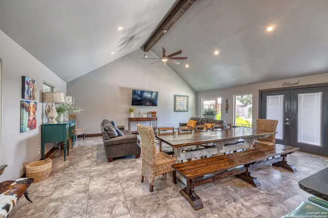 a living room with furniture a rug and a flat screen tv