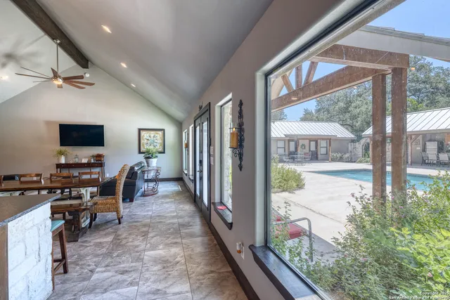 a view of a hallway with workspace and windows