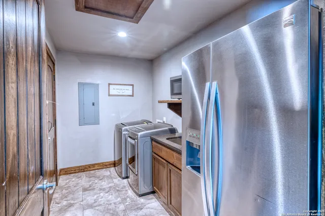 a view of a refrigerator and utility room