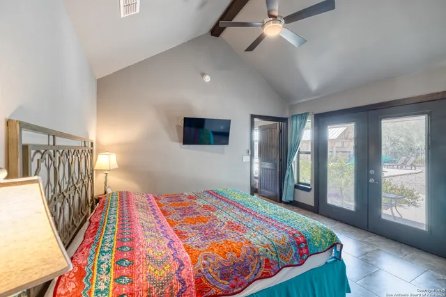 a bedroom with a bed next to a window