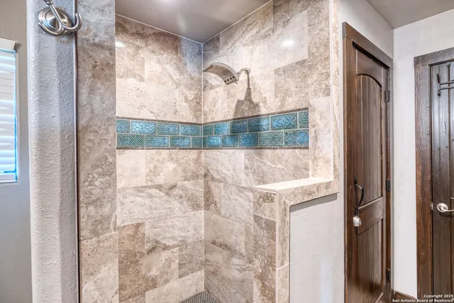 a bathroom with a bathtub and shower