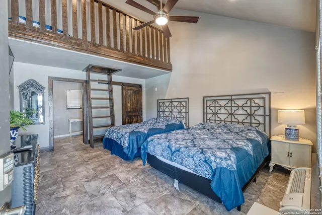 a bedroom with a large bed and a chandelier