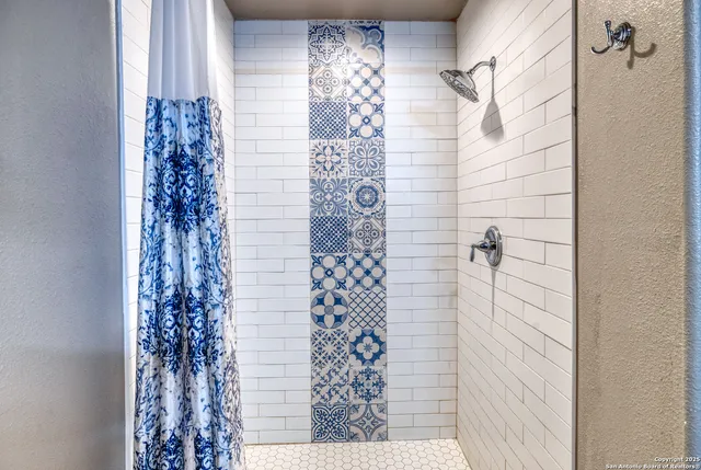 a bathroom with a shower curtain and a sink
