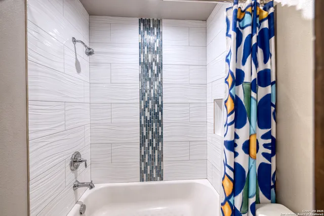 a bathroom with a bathtub and a shower