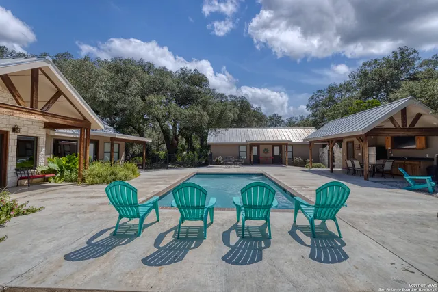 a view of a house with backyard porch and sitting area