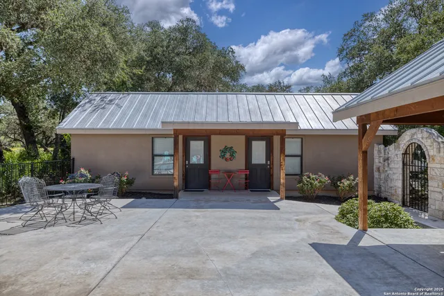 a view of a house with backyard and sitting area
