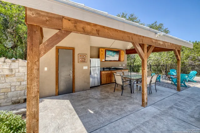 a view of a patio with table and chairs and potted plants