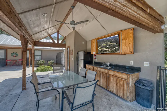 a kitchen with a table chairs and wooden floor