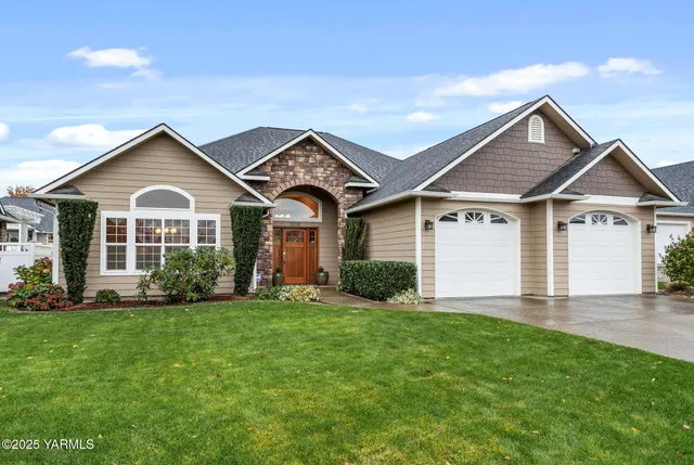 a front view of a house with a yard and garage