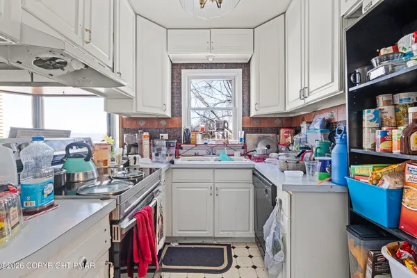 a white house with sink and wooden floor