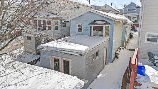 a view of house with a snow in the background