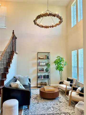 a living room with furniture and a chandelier