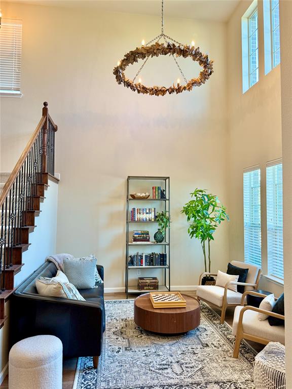 14917 Spruce Street Little Elm, TX 75068 - Photo 2 of 13 a living room with furniture and a chandelier
