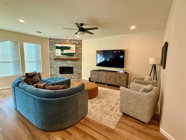 a living room with fireplace furniture and a flat screen tv