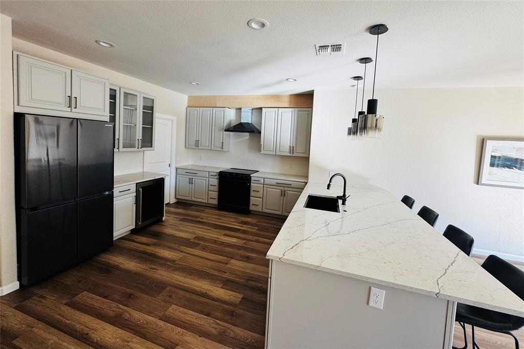 14917 Spruce Street Little Elm, TX 75068 - Photo 6 of 13 a kitchen with stainless steel appliances a refrigerator and a stove top oven