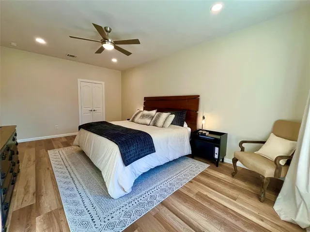 a bedroom with a large bed rug and a window