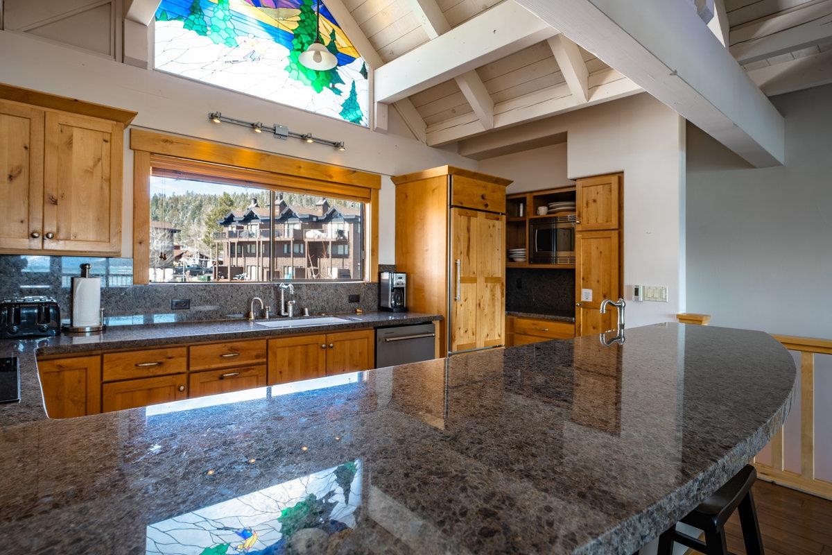 270 North North Lake Boulevard, Unit 39 Tahoe City, CA 96145 - Photo 11 of 28 a kitchen with stainless steel appliances granite countertop a sink and cabinets