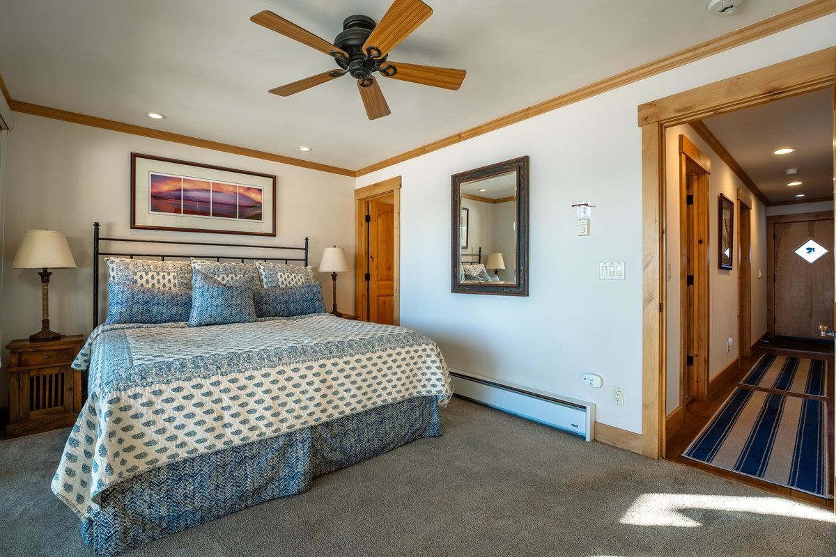 270 North North Lake Boulevard, Unit 39 Tahoe City, CA 96145 - Photo 15 of 28 a bedroom with a large bed and a chandelier