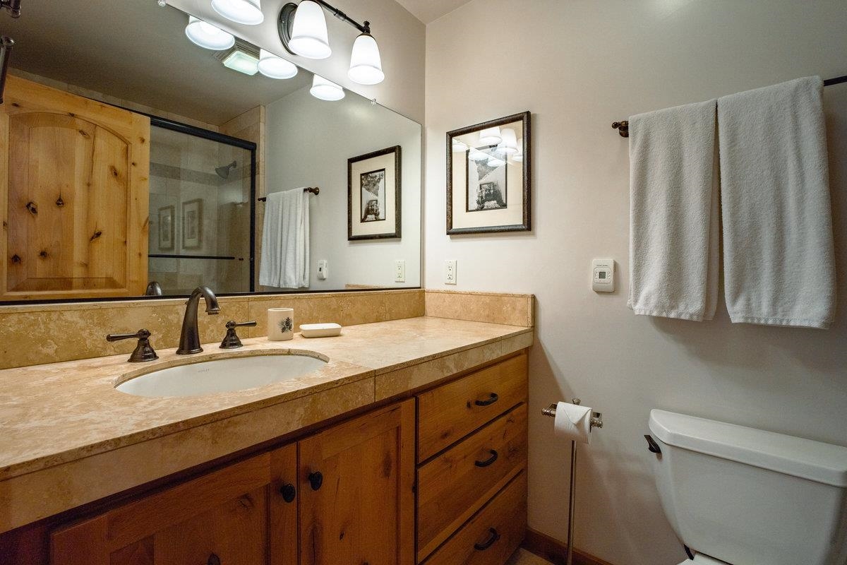 270 North North Lake Boulevard, Unit 39 Tahoe City, CA 96145 - Photo 18 of 28 a bathroom with a granite countertop sink a toilet and a mirror