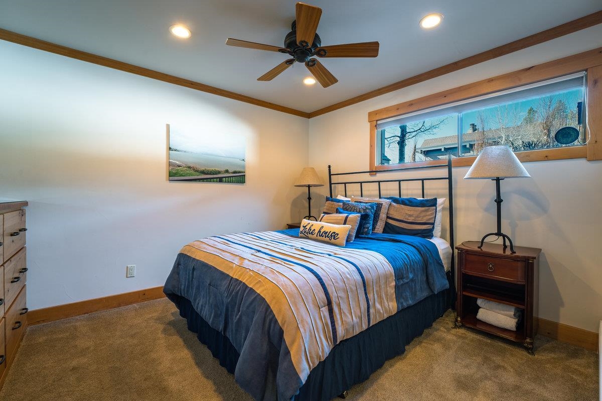 270 North North Lake Boulevard, Unit 39 Tahoe City, CA 96145 - Photo 19 of 28 a bedroom with bed and a chandelier