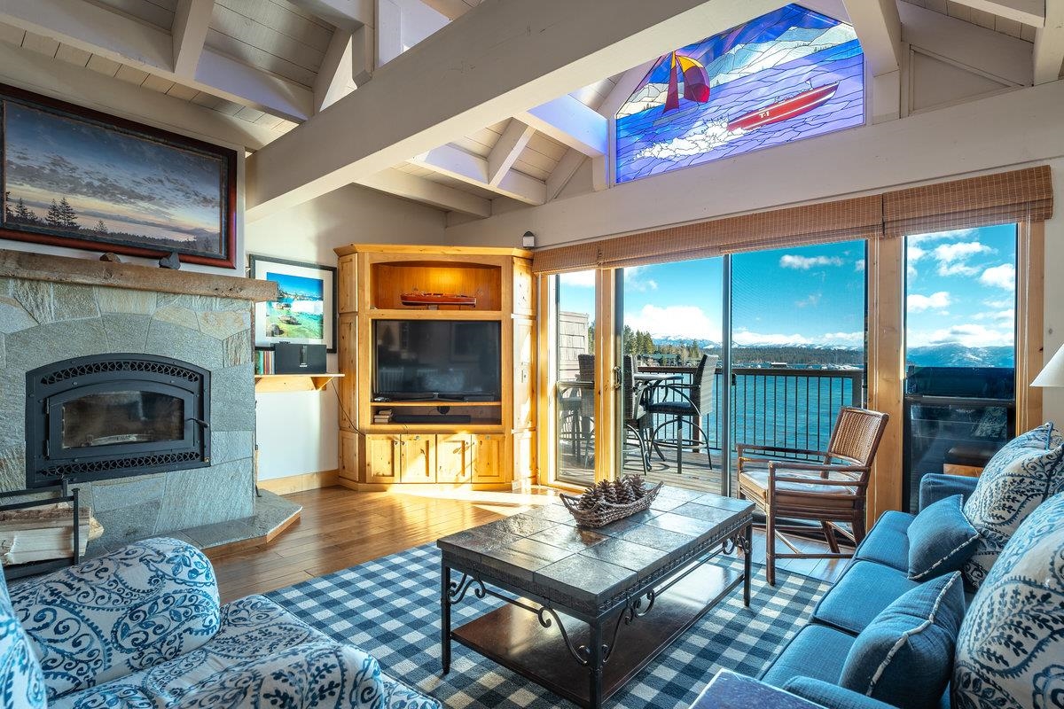 270 North North Lake Boulevard, Unit 39 Tahoe City, CA 96145 - Photo 2 of 28 a living room with furniture a flat screen tv and a fireplace
