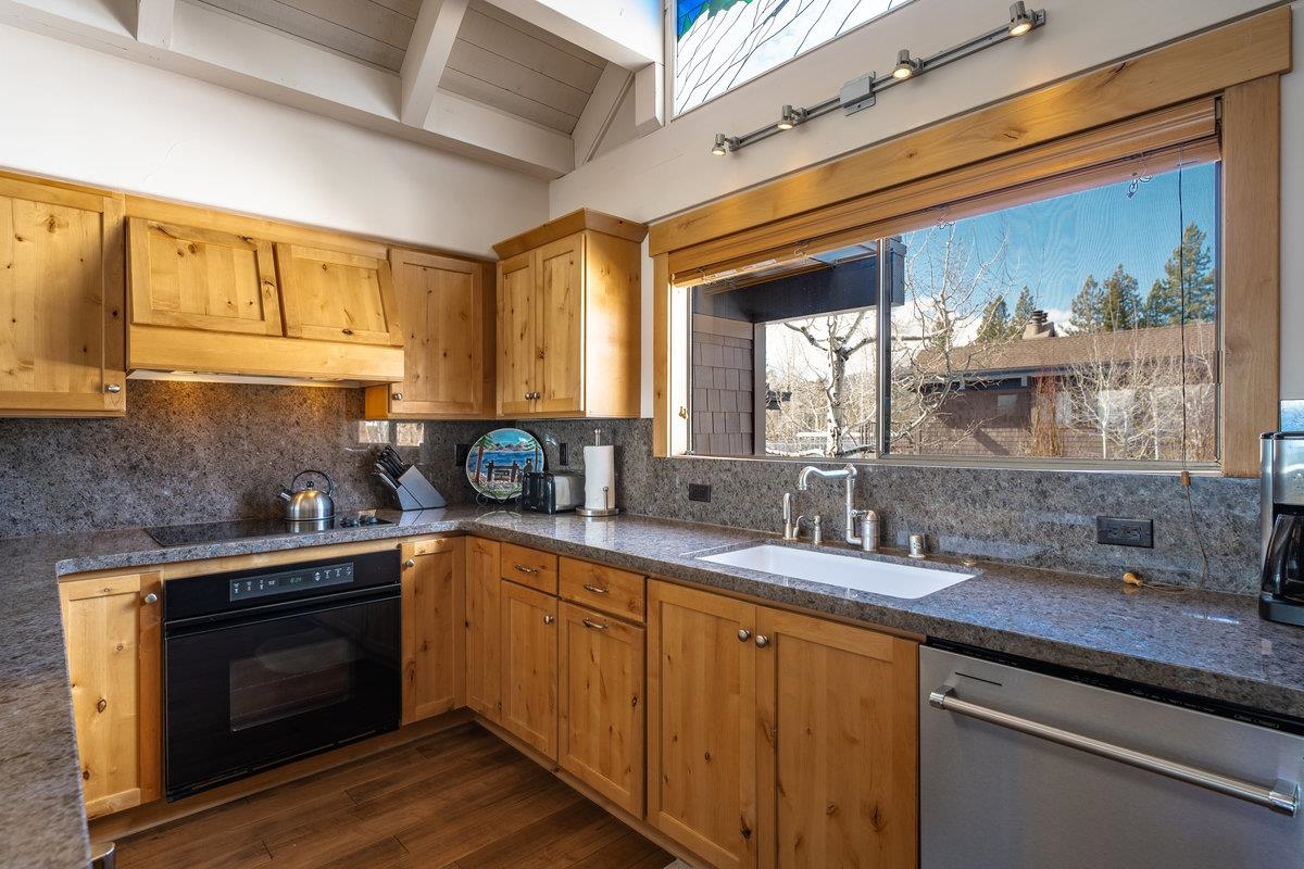 270 North North Lake Boulevard, Unit 39 Tahoe City, CA 96145 - Photo 10 of 28 a kitchen with stainless steel appliances granite countertop a sink a stove and wooden cabinets