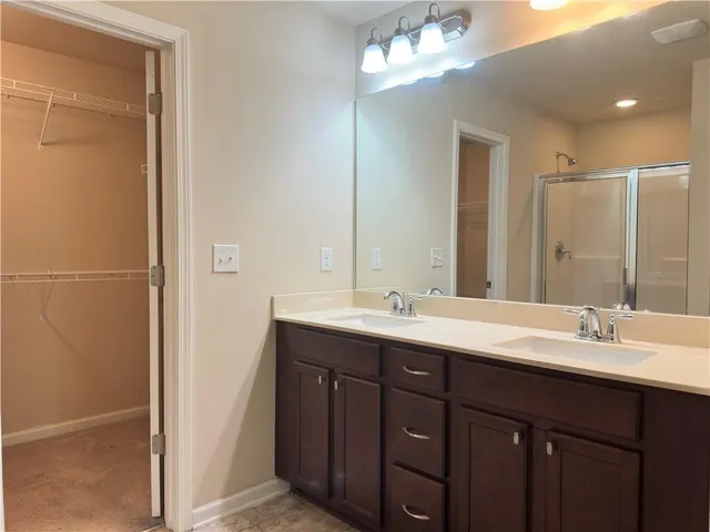 a bathroom with a double vanity sink and mirror
