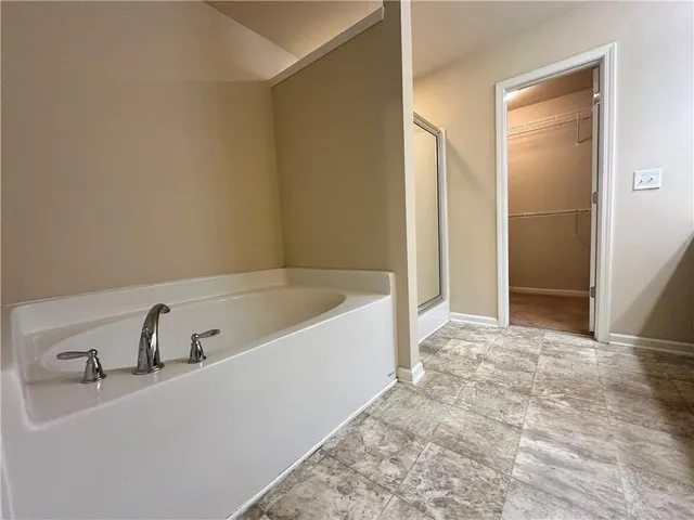 a bathroom with a bathtub and shower