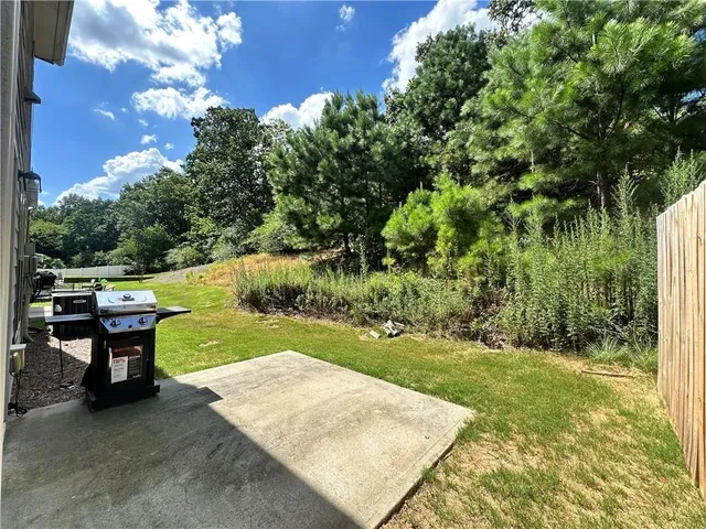 a view of a backyard with sitting area