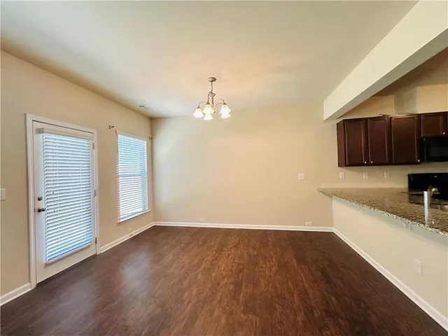 a view of a kitchen with wooden floor and a sink