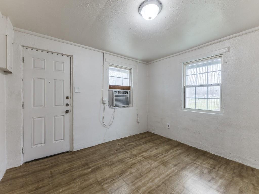 3432 Terrell Street Dallas, TX 75223 - Photo 1 of 7 an empty room with wooden floor and windows