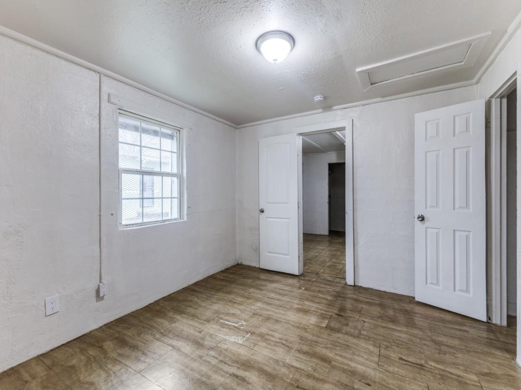 3432 Terrell Street Dallas, TX 75223 - Photo 3 of 7 an empty room with wooden floor and windows