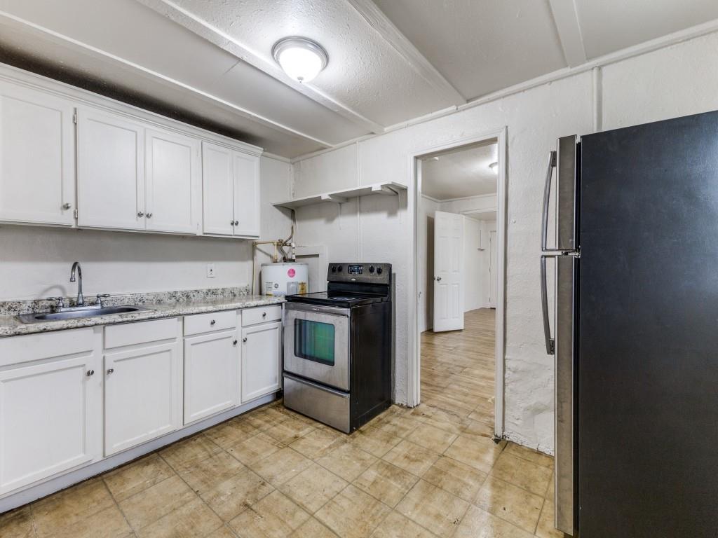 3432 Terrell Street Dallas, TX 75223 - Photo 5 of 7 a kitchen with granite countertop a refrigerator and a stove top oven