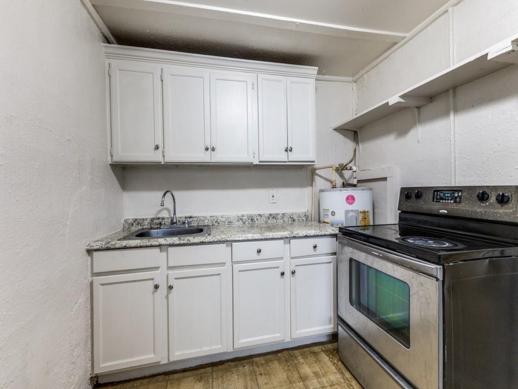 3432 Terrell Street Dallas, TX 75223 - Photo 6 of 7 a kitchen with granite countertop cabinets stainless steel appliances and a sink