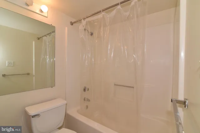 a bathroom with a toilet and shower