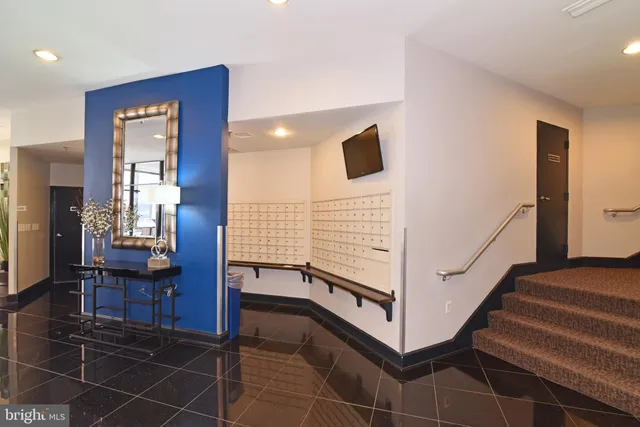 a view of hallway with stairs and furniture