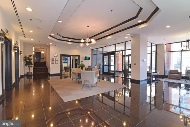 a view of a dining room with lots of furniture and a chandelier