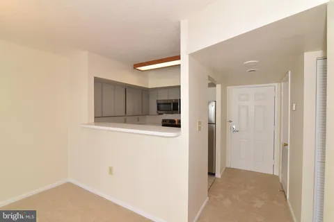 a view of a refrigerator in kitchen and wooden floor
