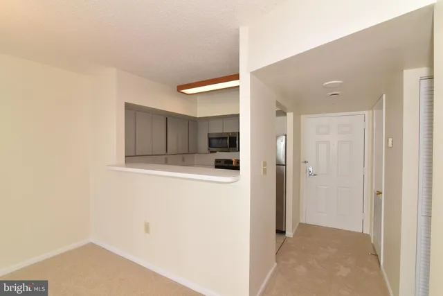 a view of a refrigerator in kitchen and wooden floor