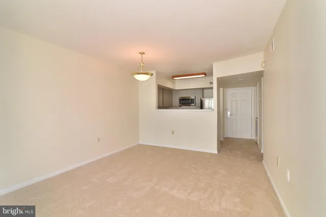 an empty room with a kitchen