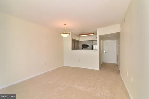 an empty room with a kitchen