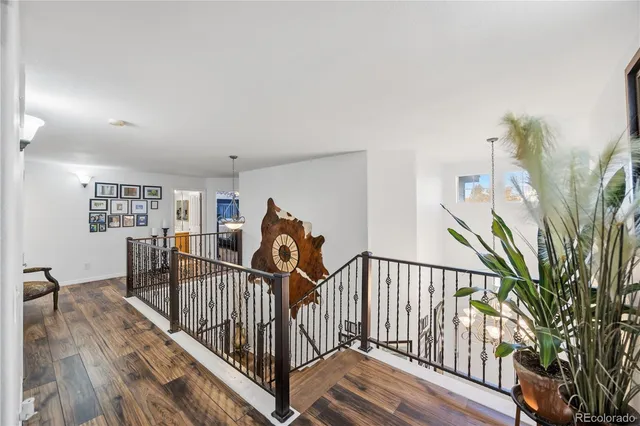 a bedroom with a large bed a flat tv screen and a dresser
