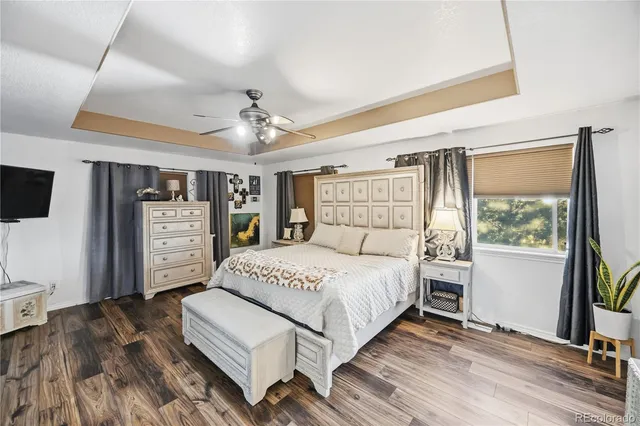 a spacious bedroom with a large bed and a chandelier