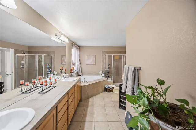 a bathroom with a tub toilet sink and mirror