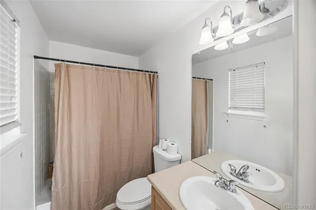 a bedroom with a bed dresser and a window