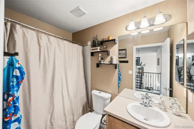 a bedroom with a large bed and a tv