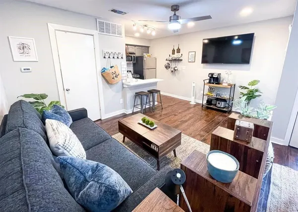 a living room with furniture and a flat screen tv