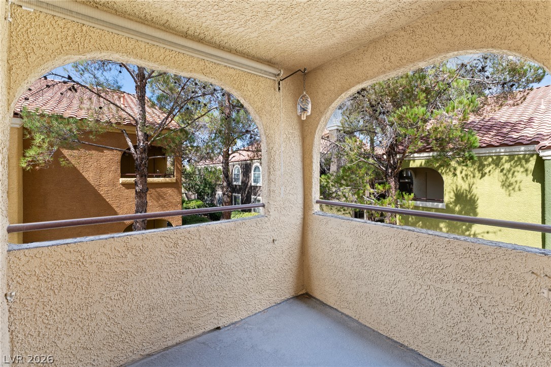 7950 West Flamingo Road, Unit 2142 Las Vegas, NV 89147 - Photo 4 of 24 Archways frame verdant views from this private, covered balcony.