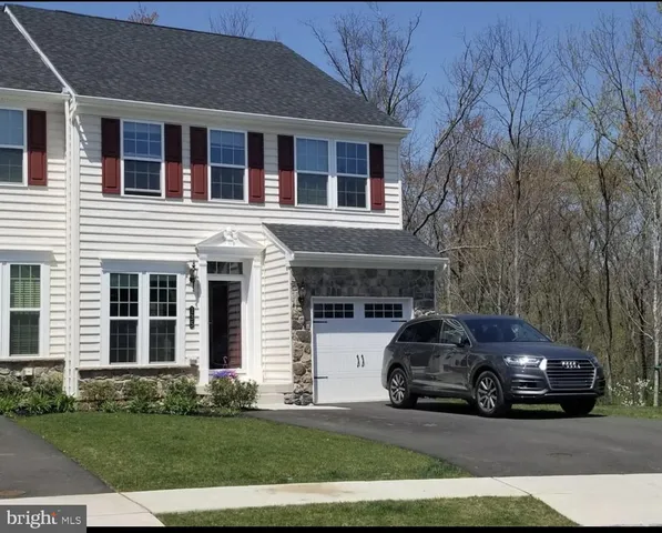 a car parked in front of a brick house