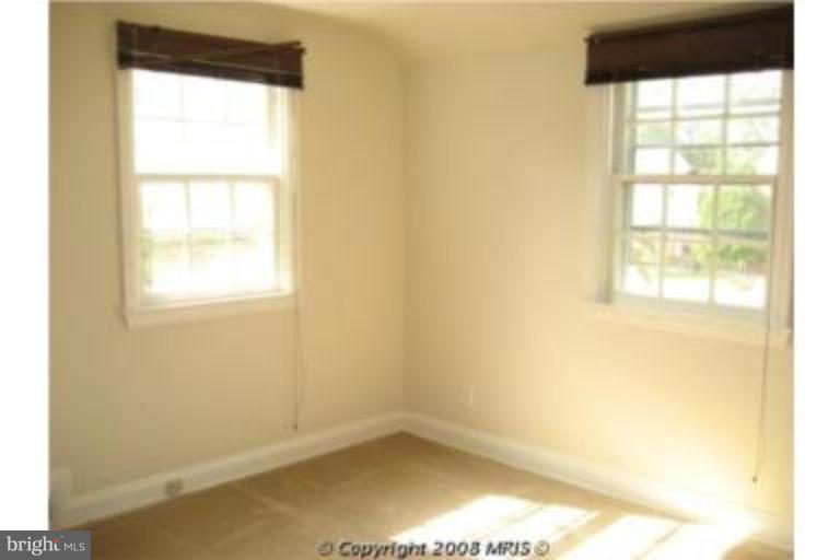 4213 Colonial Road Pikesville, MD 21208 - Photo 15 of 24 sunny corner bedroom with neutral carpet.